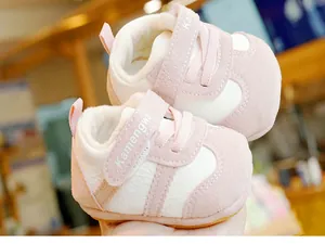 Detail view of pink baby winter boots with thick white fleece lining and velcro closure