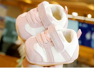 Detailed view of warm pink baby walker boots with plush lining and velcro strap closure