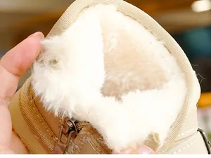 Close-up of thick faux fur lining and side zipper detail on beige winter toddler boots
