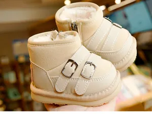 Detail of warm baby winter boots with thick faux fur lining and beige non-slip rubber soles