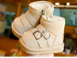 Close-up of beige winter baby snow boots featuring plush faux shearling lining and side zipper