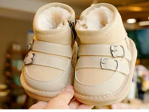 Close-up of beige toddlers snow boots with plush lining and double decorative buckles