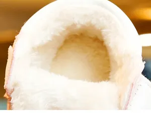 Macro shot of the thick white faux fur lining inside these warm winter baby shoes