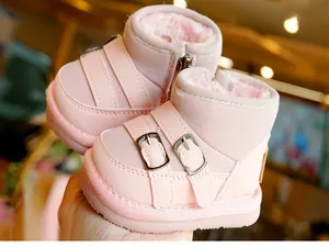 Detail of pink baby winter snow boots featuring warm faux fur lining and side zipper