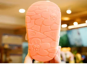 Detail of baby walking shoe sole featuring non-slip rubber texture and rabbit pattern