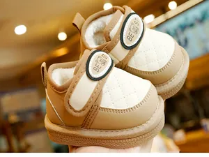 Detail of warm winter baby boots with plush lining and a cute bear velcro strap