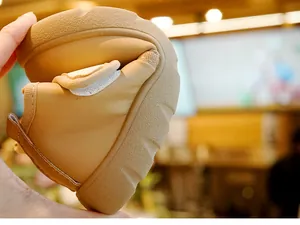 Close-up of flexible soft sole baby winter boots with easy velcro closure in khaki