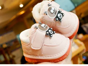 Pink winter baby bootie with warm fleece lining and orange non-slip rubber sole