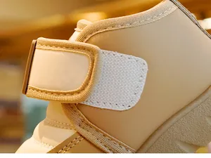 Detail of beige toddler winter boot featuring leather upper and secure velcro strap