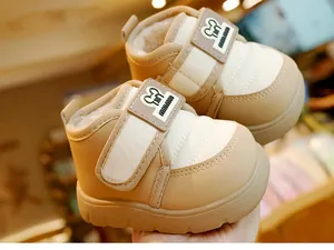 Detailed view of beige baby snow boots with warm plush lining and secure velcro strap