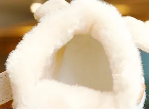 Detail view of the thick warm white faux fur lining inside these baby winter shoes