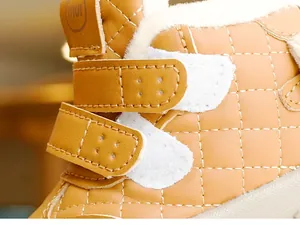 Detail of warm winter baby boots with quilted leather texture and thick fleece lining