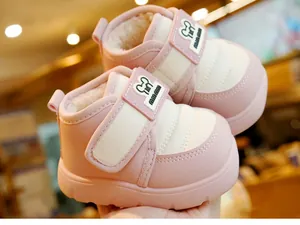 Close-up of warm baby winter boots with thick fleece lining and cute cartoon detail