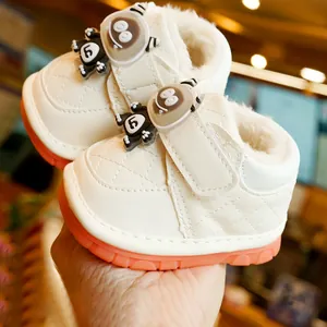 Winter fleece-lined infant shoes with non-slip rubber soles and cartoon monster detail