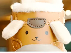 Close-up of warm winter baby shoes with thick white fleece lining and dog character