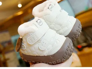 Detailed view of warm fleece lining and teddy bear logo on white baby winter boots