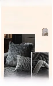 Close-up of dark grey quilted milk fleece fabric showing soft geometric square patterns
