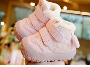 Detail of pink toddler shoes with diamond lattice pattern and warm fleece lining