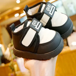 Winter fleece-lined baby snow boots with black and white contrast and velcro strap