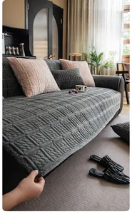 Detailed close-up of thick milk velvet sofa cover with grey square embossed texture