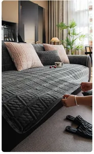 Macro detail of thick grey milk velvet sofa cover with quilted diamond texture