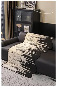 Artistic black and white striped chenille sofa cover with wavy edges on leather sofa