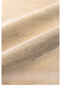 Detailed macro view of soft silicone anti-slip dots on chenille sofa cover fabric