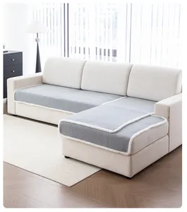 Close-up of grey plush sofa cover with white fleece border on a modern sectional sofa