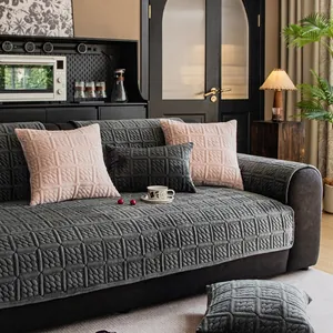 Grey quilted velvet sofa cover with geometric diamond pattern and matching pillows