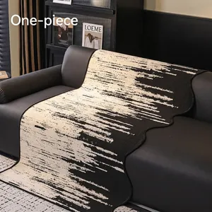 Modern chenille sofa cover with abstract black and white brushstroke pattern on leather couch