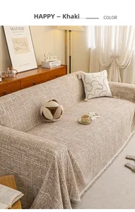 Close-up of khaki woven fabric sofa cover with rustic texture and fringe detail
