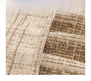 Detail of beige chenille sofa cover showing woven texture and fine edge stitching