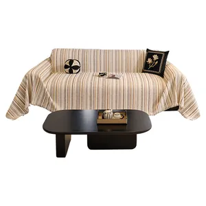 Striped cream-style sofa cover with tassels and decorative throw pillows for home decor