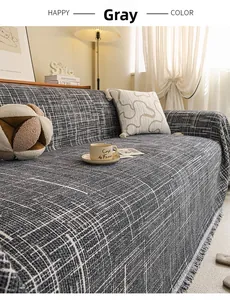 Detailed view of gray sofa cover featuring woven mesh texture and elegant tassel edges