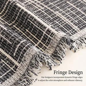 Grey woven plaid sofa cover with elegant long tassels for year-round furniture protection