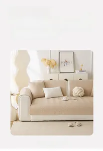 Detailed close-up of thickened beige quilted sofa cover with classic herringbone pattern