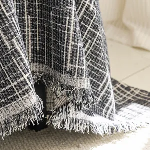 Luxurious dark grey plaid sofa cover with fringe detail and thick woven texture