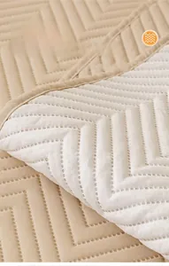 Detail of wave quilted sofa cover with non-slip soft silicone backing particles