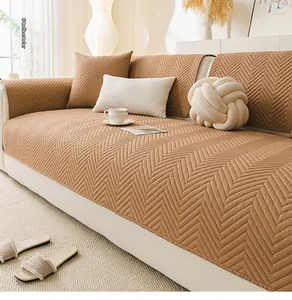 Close-up of coffee-colored quilted sofa cover with premium herringbone stitch details
