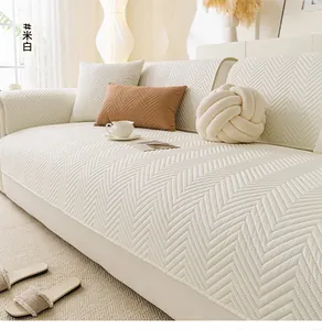 Detail of cream white sofa cover with textured chevron pattern and brushed fabric finish
