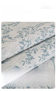 Detail of chenille sofa cover with blue leaf pattern and soft textured fabric surface