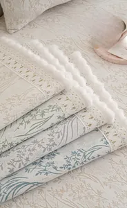 Close-up of soft chenille sofa cushions with floral patterns and plush fringe edges
