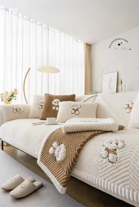 Detail of plush sofa cover with wave texture and white cartoon dog embroidery