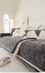 Detail of plush rabbit fur sofa cover with 3D geometric texture and soft cream style finish