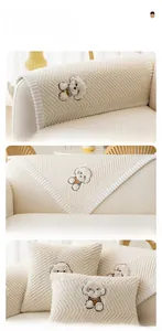 Detail of cream plush sofa cover set with dog embroidery and chevron textured fabric