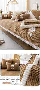 Detail of coffee-colored teddy fleece sofa cushion with white bichon embroidery and wavy texture