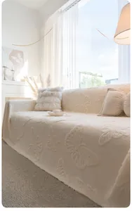 Detail of soft cream-colored comfort cotton velvet sofa cover with butterfly relief pattern