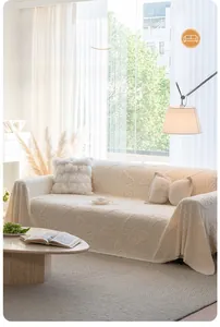 Detailed texture of cream fleece sofa cover with 3D butterfly patterns and matching pillows