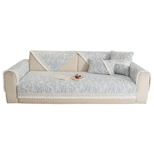 Light blue floral chenille sofa cover with elegant lace borders and pom-pom trim
