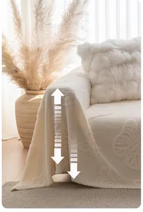 Detail of off-white sofa cover with textured butterfly jacquard and natural drape effect